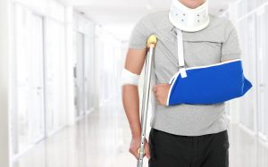 portrait of injured young man use crutch and arm sling